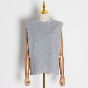 Detail of grey sleeveless T-shirt with padded shoulders on a wooden mannequin