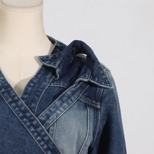 Detail of overlapping neckline and layered shoulder ruffles on denim jacket