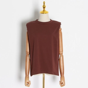 Detail of dark brown sleeveless t-shirt with padded shoulders on a mannequin