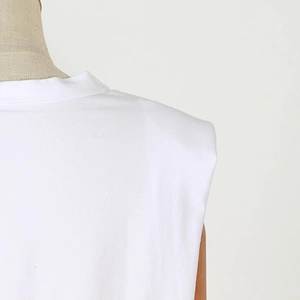 Detailed view of white sleeveless T-shirt shoulder with premium knit texture on mannequin