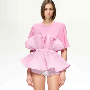 Detail of the elegant pink T-shirt featuring pleated ruffles and ruffled hem design
