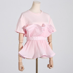 Detail of light pink slim fit top with ruffled hem and pleated design textures