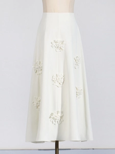 Elegant white A-line maxi skirt with high waist and decorative 3D floral applique detail