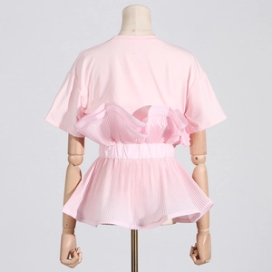 Rear view of pink short-sleeve top showing intricate pleated ruffle layers and slim waist