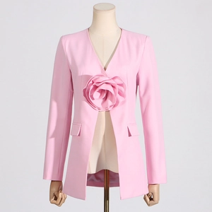 Detail of a pink women's blazer featuring a large 3D fabric rose and V-neck design