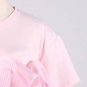 Detail of pink crew neck T-shirt featuring pleated ruffle layers and knit texture