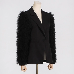 Detail of layered black tulle pleated sleeves on a slim-fit fashion blazer jacket