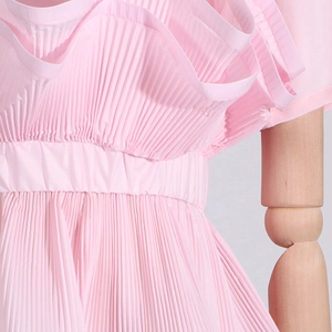 Close-up of pink pleated ruffles and tiered design on a slim fit women's summer T-shirt