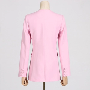 Detail view of pink slim-fit blazer showing buttoned cuffs and flap pockets