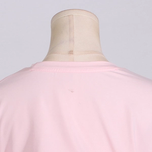 Detail of the pink round neck T-shirt showing neat stitching and reinforced collar seams