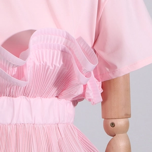 Macro view of light pink pleated ruffle details on slim-fit summer women's T-shirt