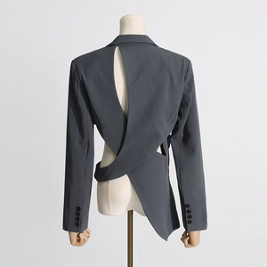 Detail showing the asymmetric open back design and cross-cut tailoring of this grey blazer