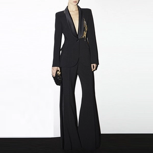 Detail of satin peak lapel and gold embroidery on black tailored women blazer set