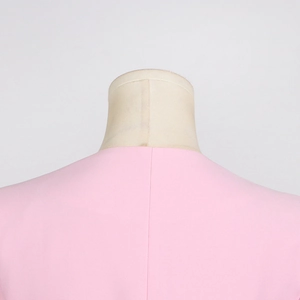 Close-up of pink cropped blazer back collar with neat stitching on smooth fabric
