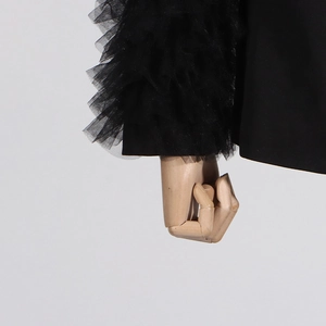 Detail of multi-layered mesh ruffles and pleated lace sleeves on black blazer jacket