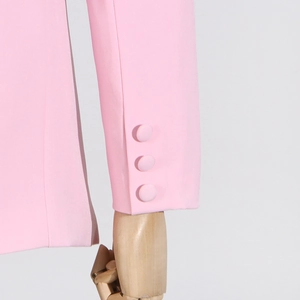 Detail of light pink cardigan sleeve with three matching fabric covered buttons