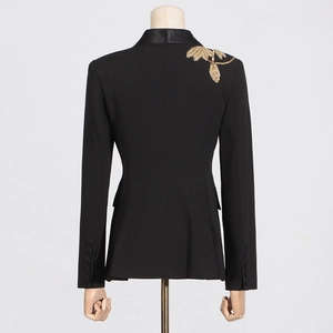 Detail of black fitted blazer showing gold leaf embroidery and leather collar on the back