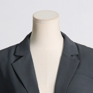 Detailed view of the charcoal grey blazer notch lapel and shoulder tailoring details