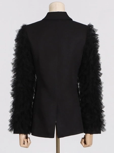 Women's black blazer with dramatic pleated mesh sleeves and ruffle details, back view