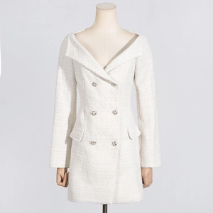 Detailed texture of off-white tweed dress with rhinestone buttons and off-shoulder neckline