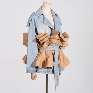 Detail of light blue denim jacket with khaki ruffled trims and waist belt feature