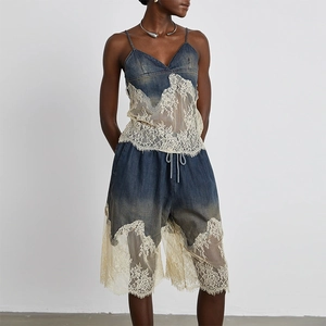 Close-up detail of vintage denim shorts with fine lace patchwork and drawstring