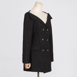 Close-up of black tweed dress featuring metallic threads and vintage gold buttons