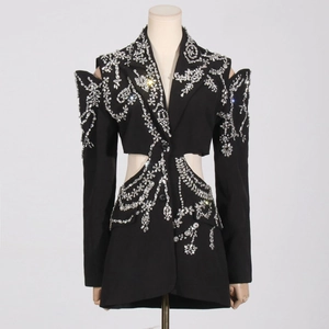 Detail of black blazer featuring intricate silver rhinestone floral patterns and cut-outs