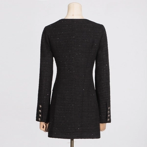 Detailed back view of a black tweed dress featuring sparkling sequins and waist-cinched cut