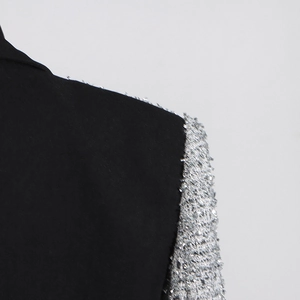 Detail showing silver sequin embellishments on black wool blend blazer shoulder