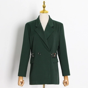 Detail view of dark green blazer featuring unique metal ring buckle and waist tailoring