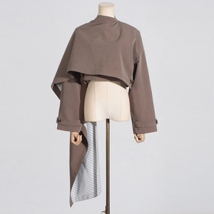 Detail of coffee-colored asymmetrical cropped blazer showing the striped lining and draping