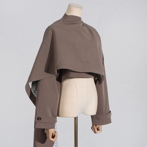 Detailed view of earth-brown cape blazer featuring striped lining and shoulder strap details
