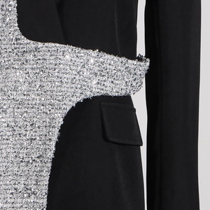 Detail view of black blazer with shimmering silver sequin patchwork and side pocket