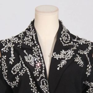 Detail of luxurious black blazer featuring intricate hand-beaded crystal floral embroidery
