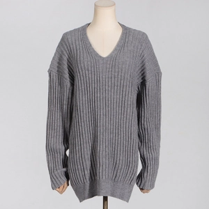 Detail of grey V-neck oversized knitted sweater featuring vertical ribbed texture and drop shoulder