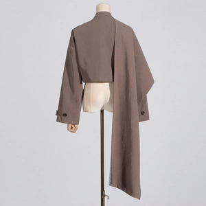 Detailed view of dark brown cropped blazer featuring unique asymmetrical long side drape design