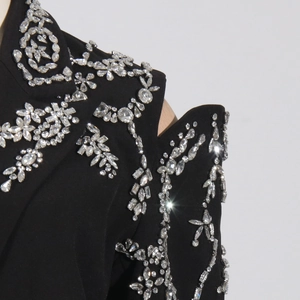 Close-up of intricate silver rhinestone floral embroidery on black luxury blazer