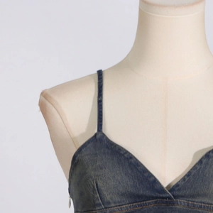 Close-up of dark blue denim camisole top with V-neckline and distressed texture details