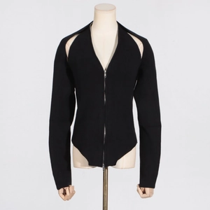 Detail of black ribbed knit top showing front zipper closure and cutout shoulder design