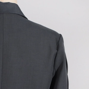 Detail of premium grey suit jacket shoulder and collar with high-quality refined texture