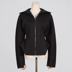 Close-up of structured black scuba jacket with standing collar and peplum hem details