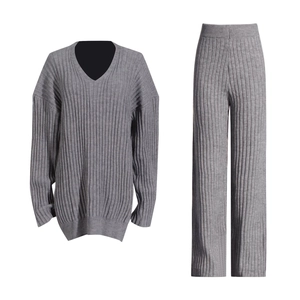 Detailed flat lay of grey V-neck knit sweater and high-waist wide-leg trousers set