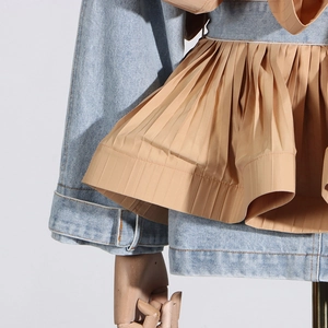 Detail view of denim jacket with khaki pleated ruffle trim and contrast stitching