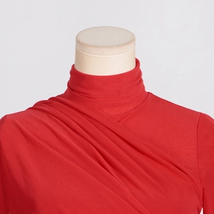 Detail of red mesh long sleeve top featuring mock neck and elegant ruched pleats design