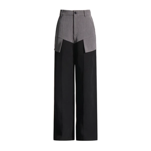Detailed view of high-waist grey and black contrast patchwork wide-leg trousers