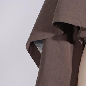 Detail of dark brown twill blazer fabric featuring high-quality striped inner lining