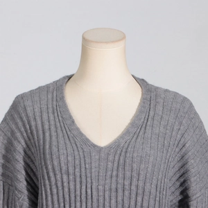 Close-up of grey V-neck ribbed knit sweater showing soft texture and premium stitching