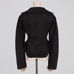 Rear view of a black structured short jacket showing minimalist tailored waist design