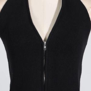 Close-up of black ribbed knit vest featuring a metallic silver front zipper detail